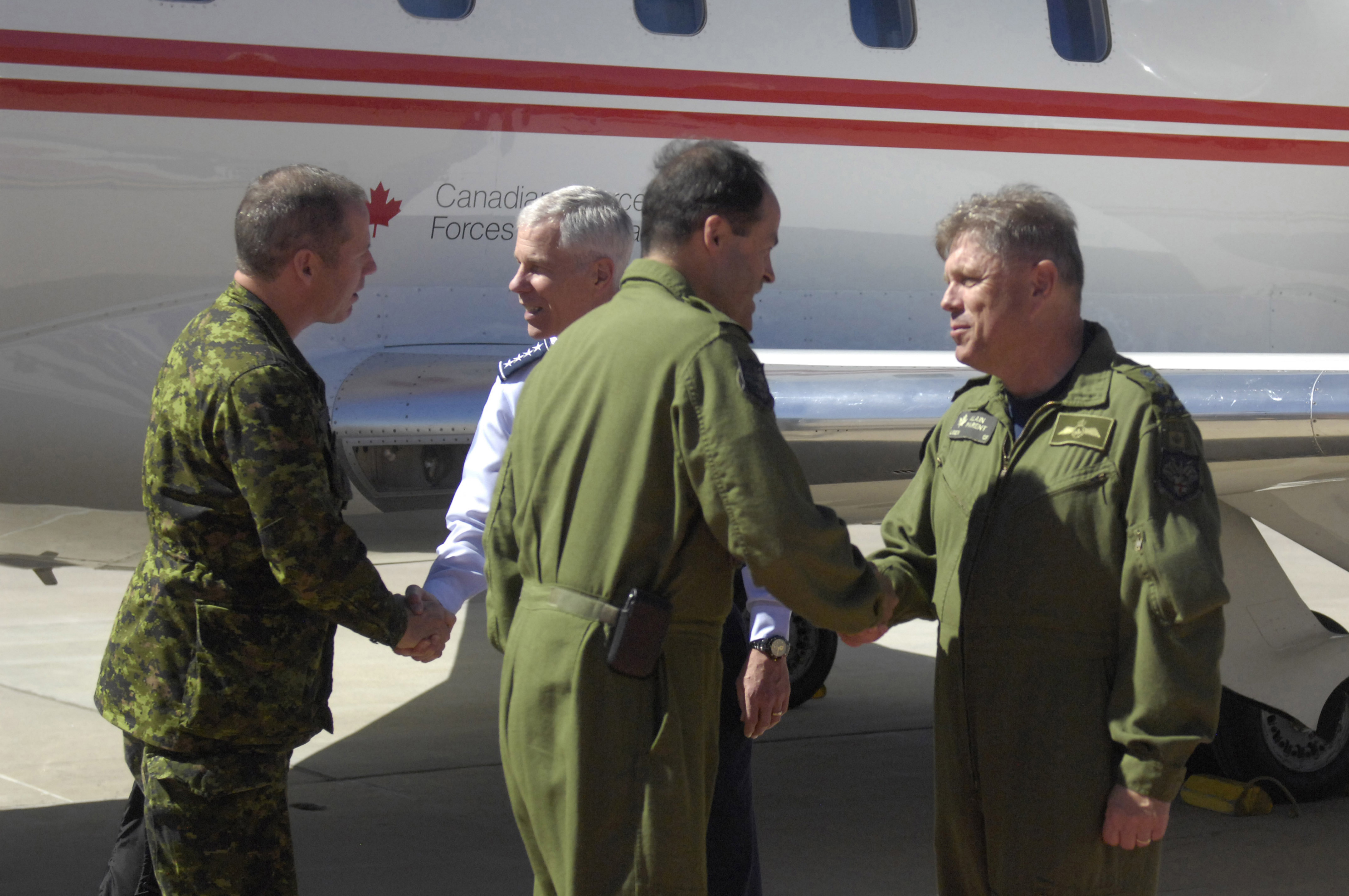 The Canadian Chief of Defense Staff General Tom Lawson and the Canadian Forces Chief Warrant Officer, Chief Warrant Officer Kevin West shake hands with the North American Aerospace Defense Command (NORAD) Deputy Commander, Lieutenant-General Alain Parent and Gen. William L. Shelton, Commander, Air Force Space Command, during their arrival at Peterson Air Force Base, Colo.  The purpose of the visit was to meet with NORAD Commander General Jacoby, Deputy Commander Lieutenant-General Parent and other senior leaders in order to gain additional insight into and appreciation of the Commands' unique missions, capabilities and advancement in the previous year and understand critical issues facing NORAD and USNORTHCOM in today's security environment. 
