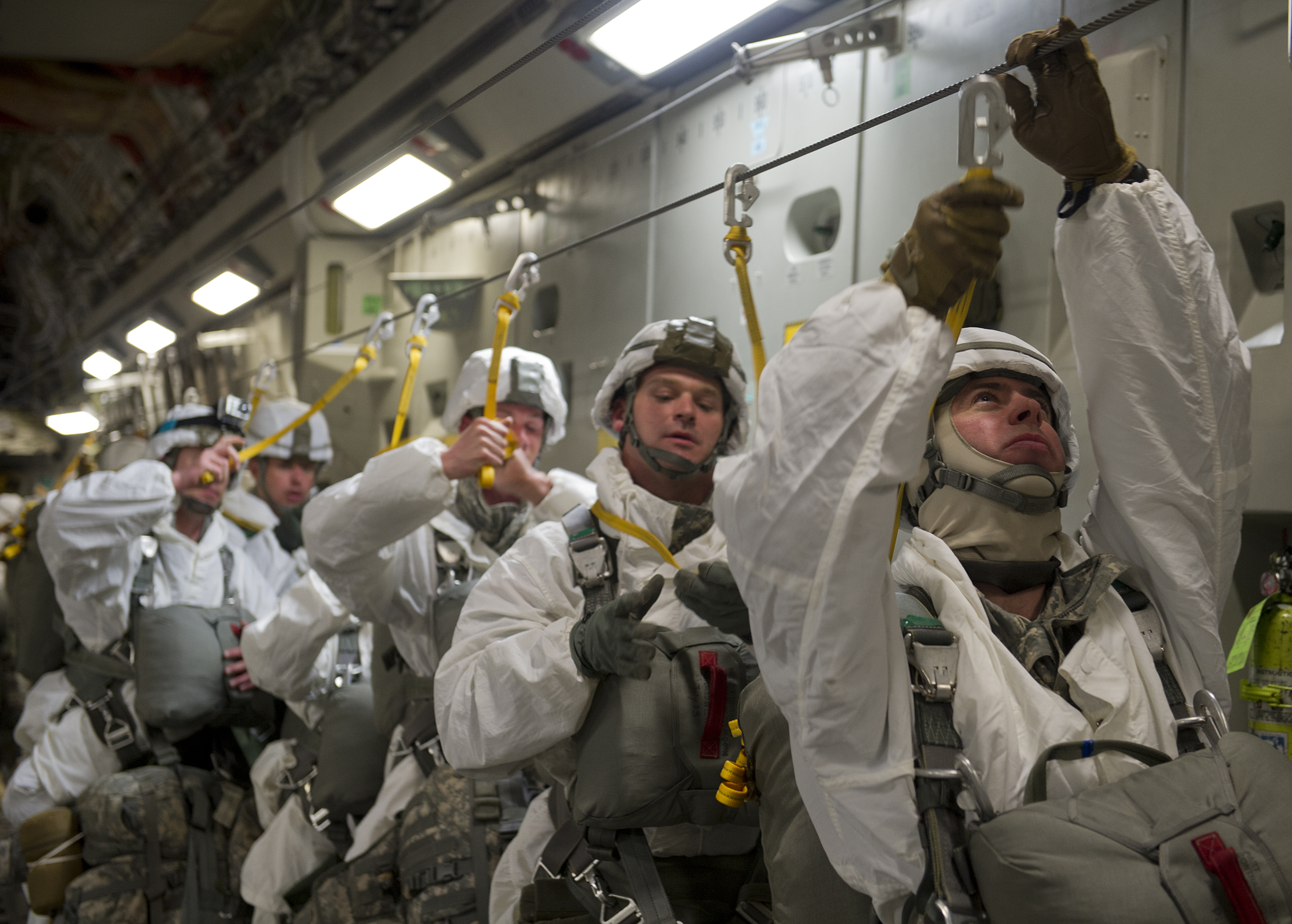 Army Maj. Aaron Williams (right), 2nd Engineer Brigade, 6th Engineer Battalion (Combat)(Heavy), battalion executive officer, secures his static line to his parachute before jumping out of a C-17 Globemaster III during Arctic Pegasus, May 1, 2014. Arctic Pegasus is a multi-component, joint exercise that will further refine planning and mission capabilities between U.S. Army Alaska, the U.S. Air Force, the Alaska National Guard, and the state of Alaska.